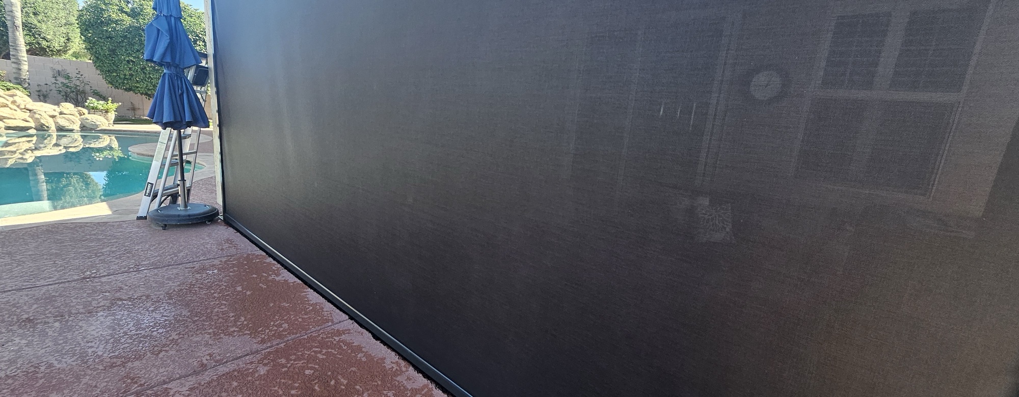 Roll-down patio sunshade cleaned and restored by ScreenRevive at a Mesa home