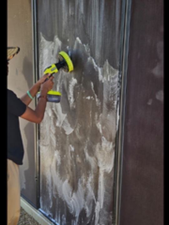 Motorized brush deep cleaning a window sunscreen during a ScreenRevive visit in Tempe