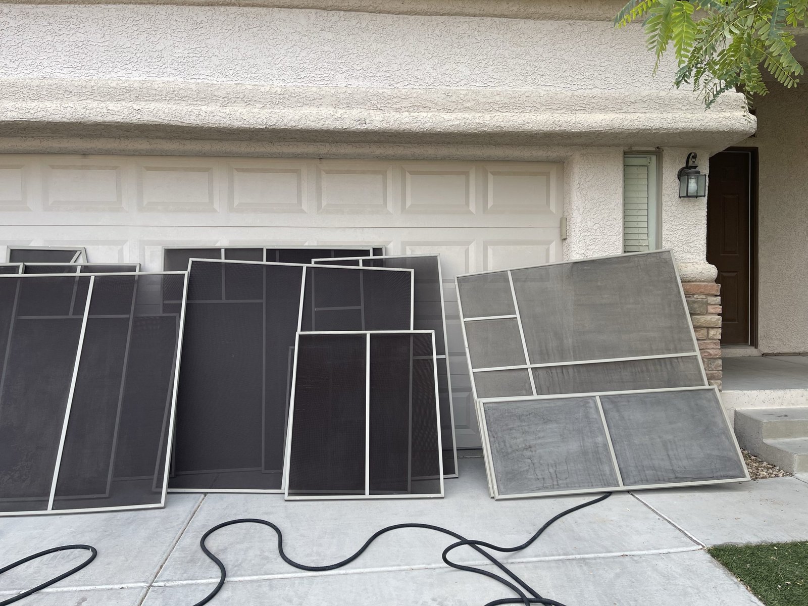 Restored sunscreens on a Chandler driveway next to panels not yet treated